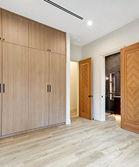 Spacious Room with Wooden Flooring and Tall Cabinet Doors