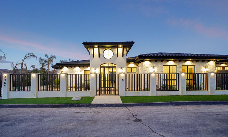 Modern Residential Home with Elegant Exterior Lighting and Gated Entrance